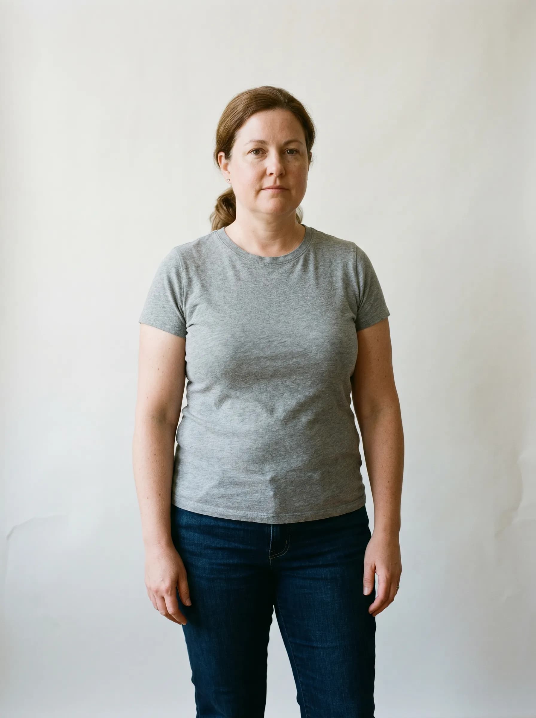 Editorial reconstruction of Danielle at baseline, neutral studio backdrop, soft window light