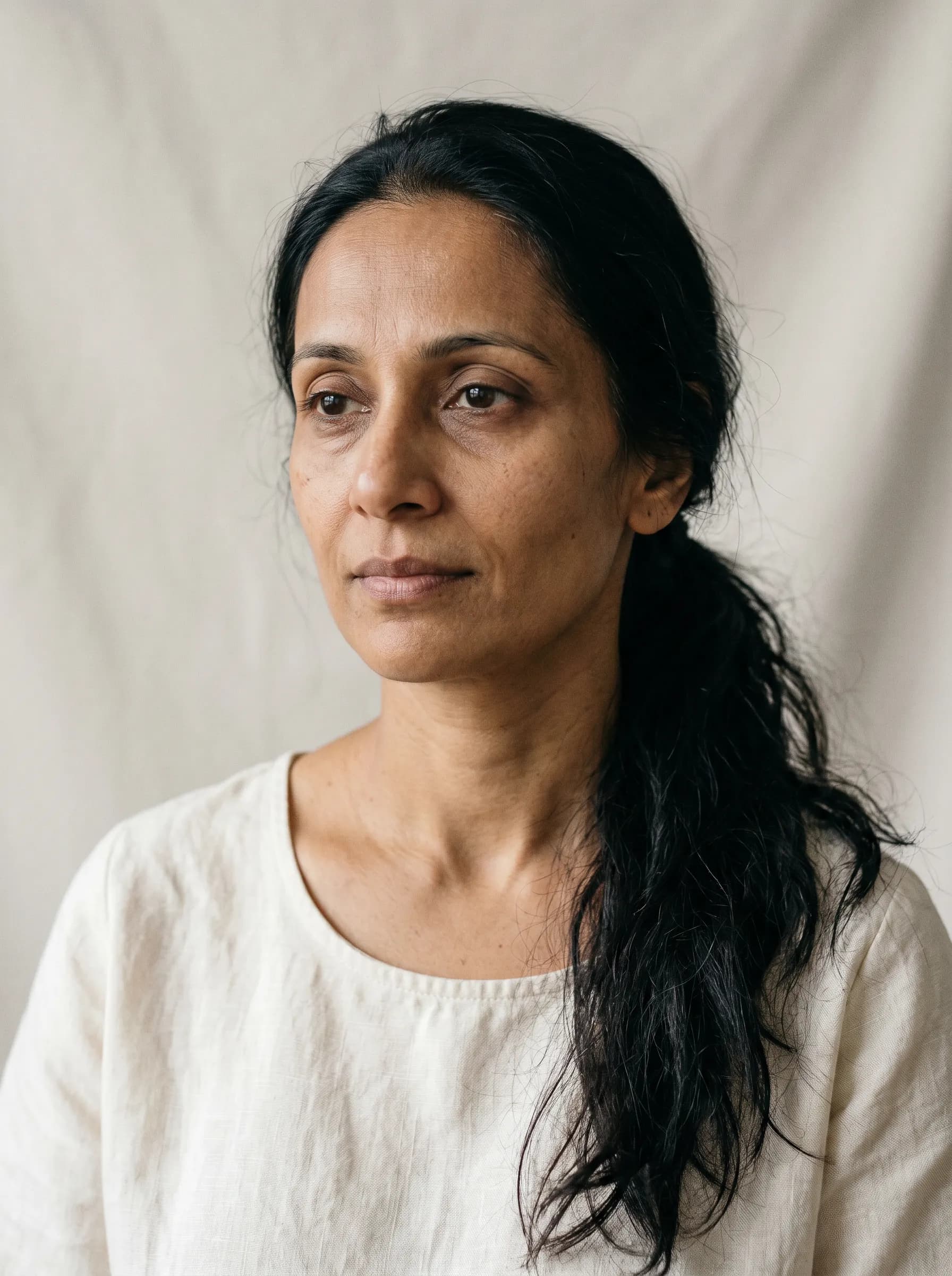 Editorial reconstruction of Priya at GLP-1 month three with subtle facial volume loss